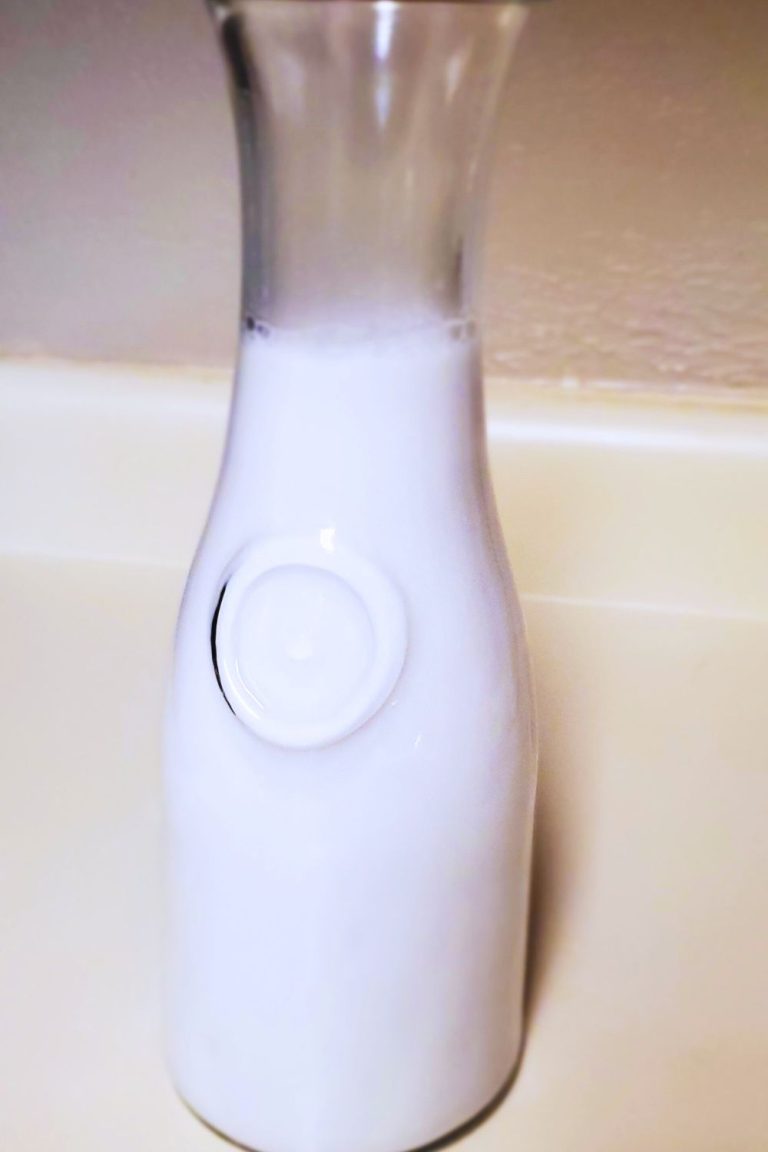 Stylish Tall glass bottle with coconut milk inside style and stewardship dot com