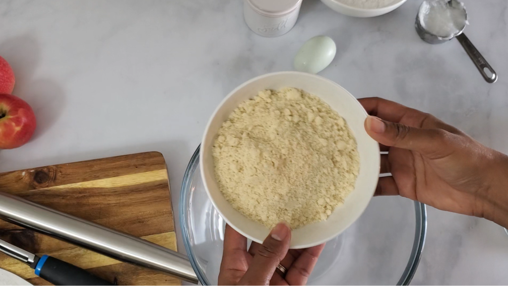 hands holding a bowl of almond flour