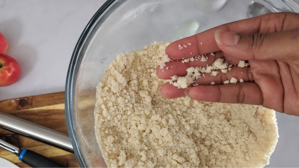 Hand over a bowl of flour showing crumb texture