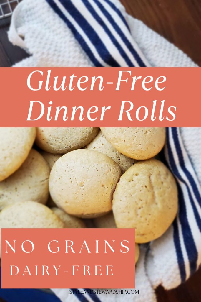 Gluten-free dinner rolls without rice piled on top of a striped kitchen towel. 