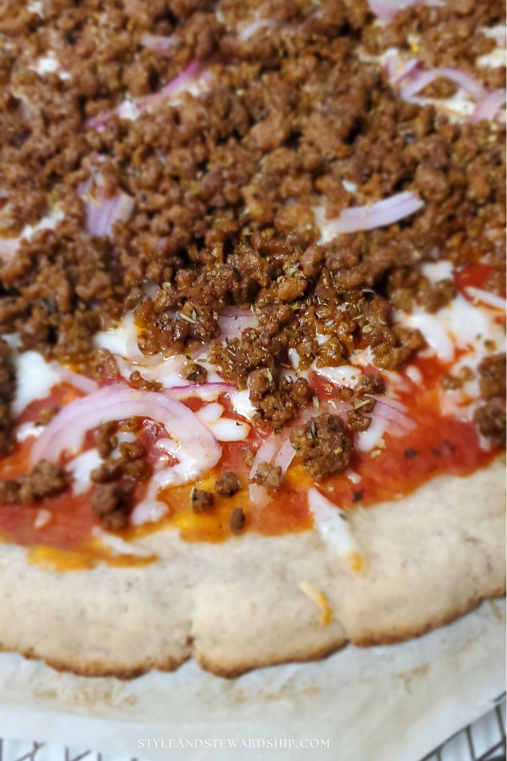 Gluten-free and grain -free pizza crust with red onions beef crumbles