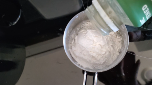 Almond milk being poured in a measuring cup