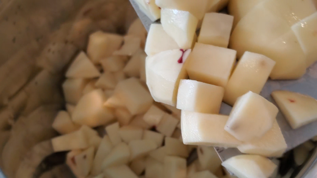potatoes being added to Instant Pot