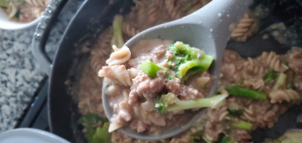 gray staub cast iron skillet with creamy noodles beef and broccoli