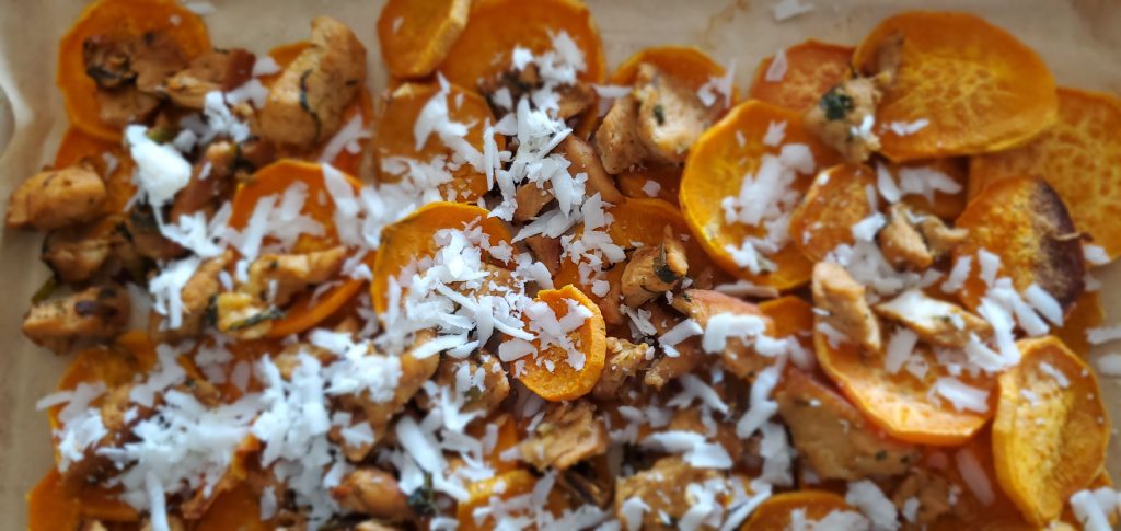 layered sweet potato slices with chicken topped with white cheese