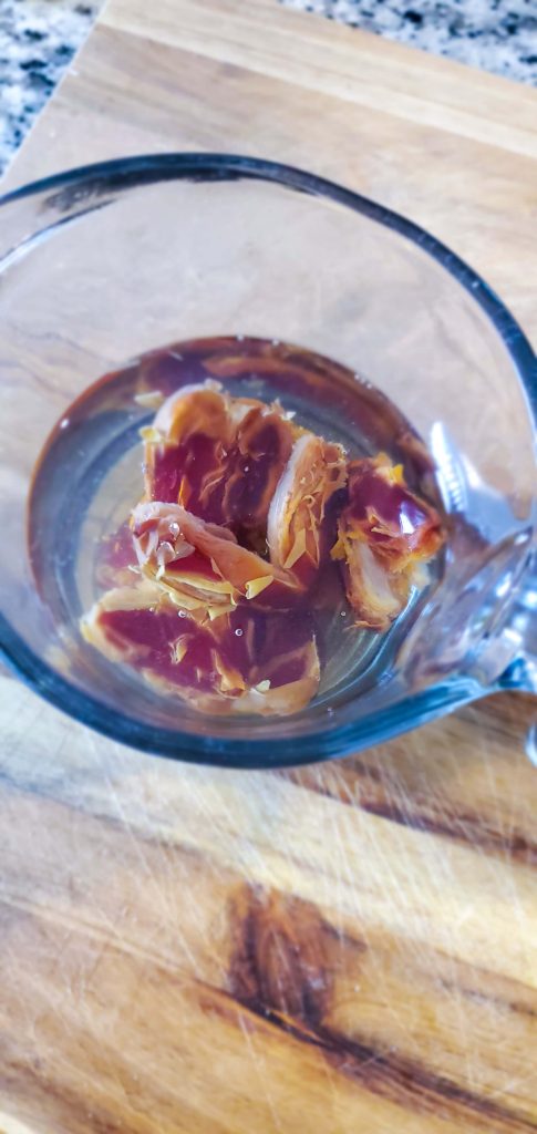 Dates in a glass measuring cup soaking in water