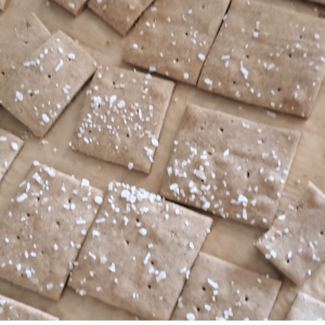 Large pan of tan crackers with large salt on top