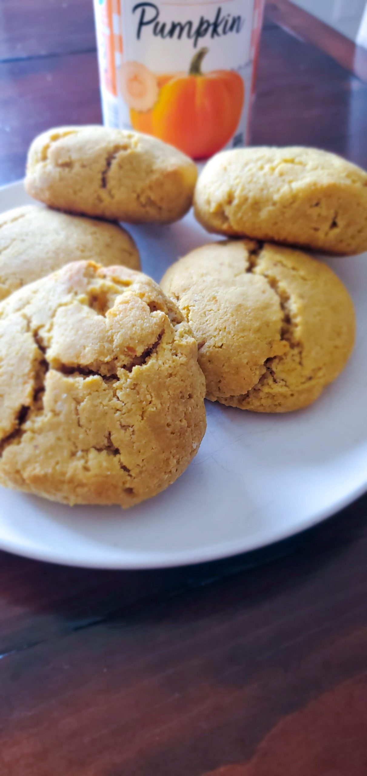 Pumpkin biscuits on a white plate with a can of pumpkin puree behind.