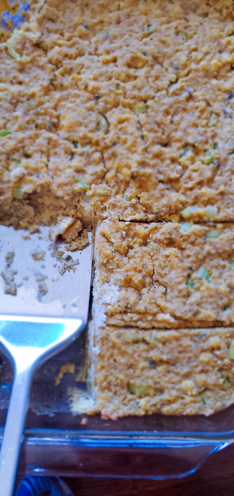 A large pan with cornbread dressing and bits of celery is shown throughout. A large metal spatula is also pictured.